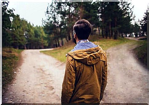 Boy standing at a crossroads.