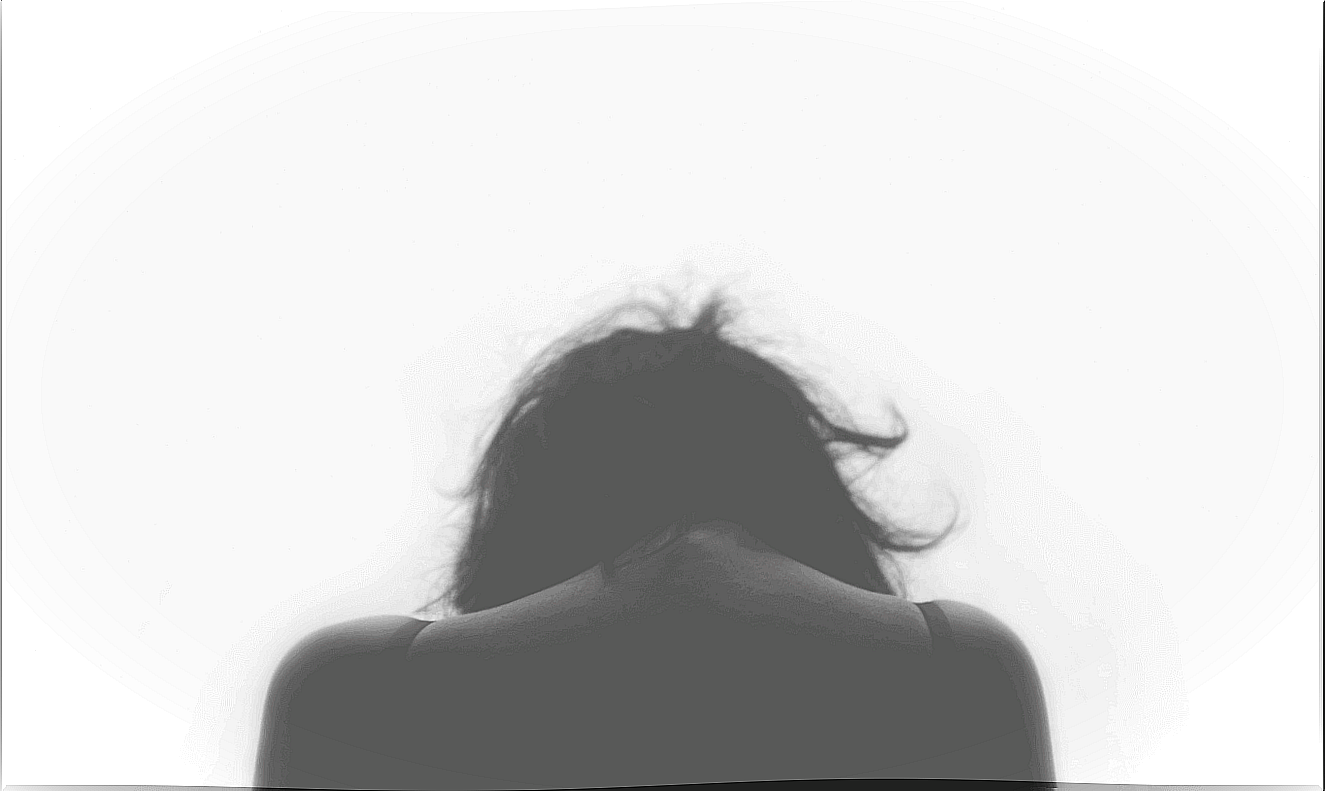 Woman from behind with her head bowed down