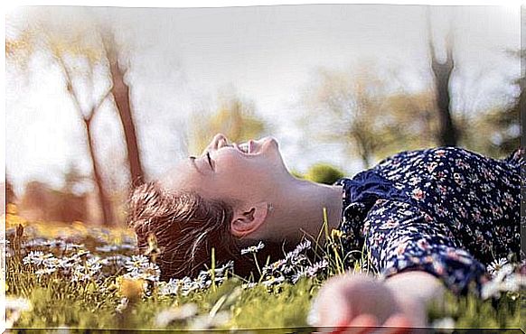 Happy girl lying on the lawn