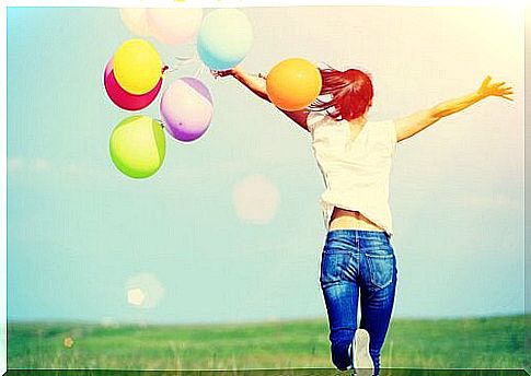 Happy woman with colorful balloons