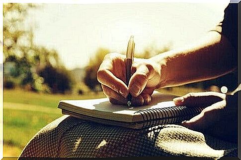 Person writing on a diary