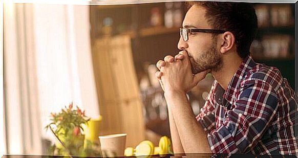 Boy with glasses sitting thinking