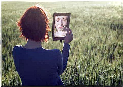 Girl looks in the mirror to know herself and be happy.