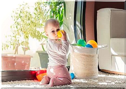 Baby boy playing with balls.