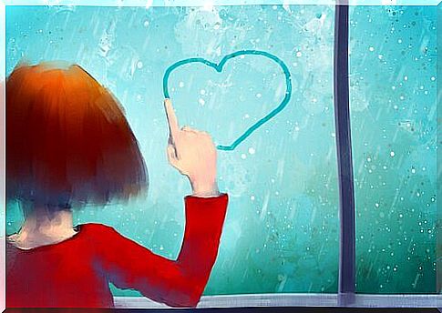 Little girl drawing heart on window with her finger