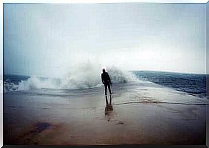 Man in front of the sea waves.