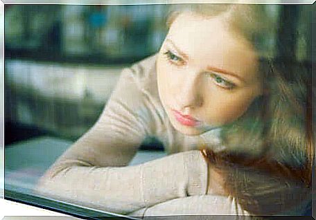 Girl sitting in front of the window.