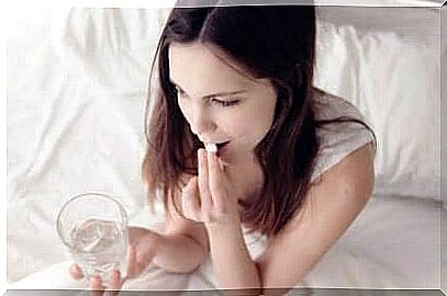 Girl swallowing a pill.