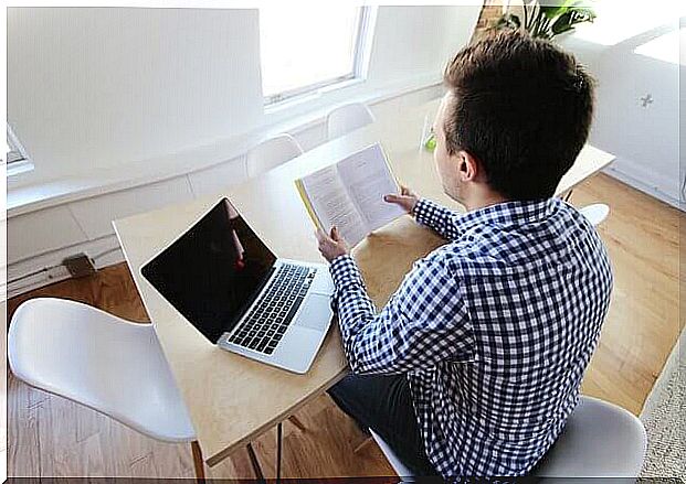 Man with book and computer