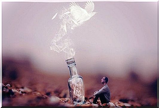 Man sitting in front of giant bottle from which a dove comes out