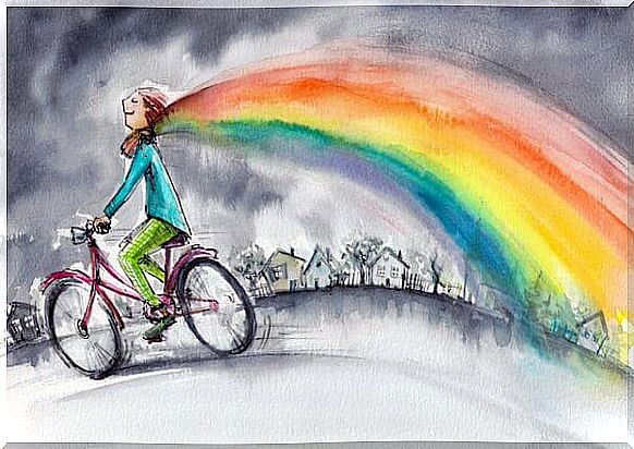 Girl on bicycle with rainbow scarf