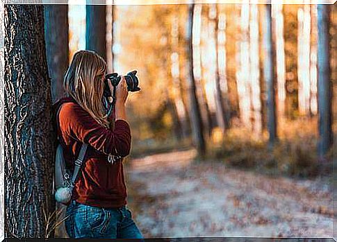 Girl taking a photograph.