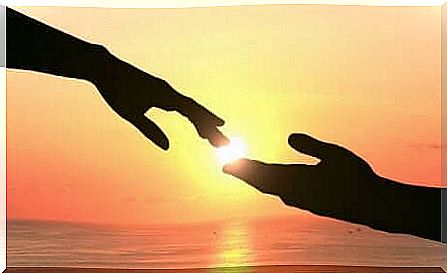 Hands touching each other at sunset