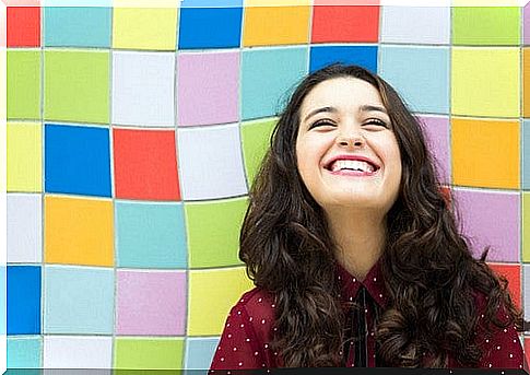 Smiling woman on colored tiles.