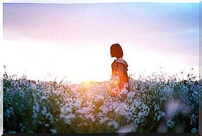 Girl seeks the opposite of depression in a field of flowers.