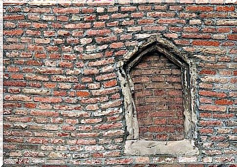 Broken window covered with bricks