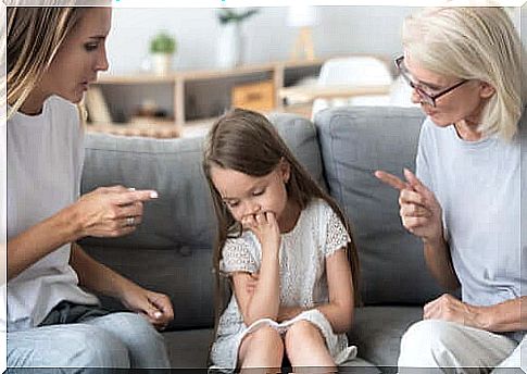 Mother and grandmother scolding a little girl