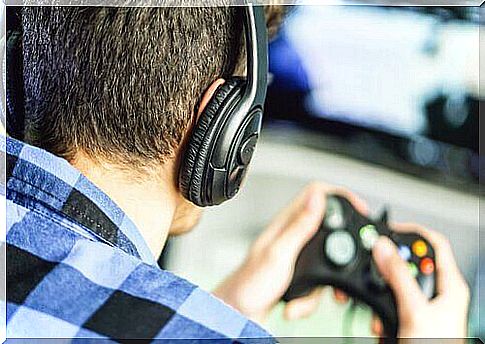 Boy with headphones plays video games