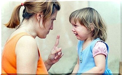 Little girl crying while her mother scolds her